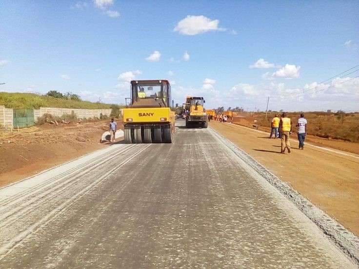 SIDC road construction crew compacting a new road surface